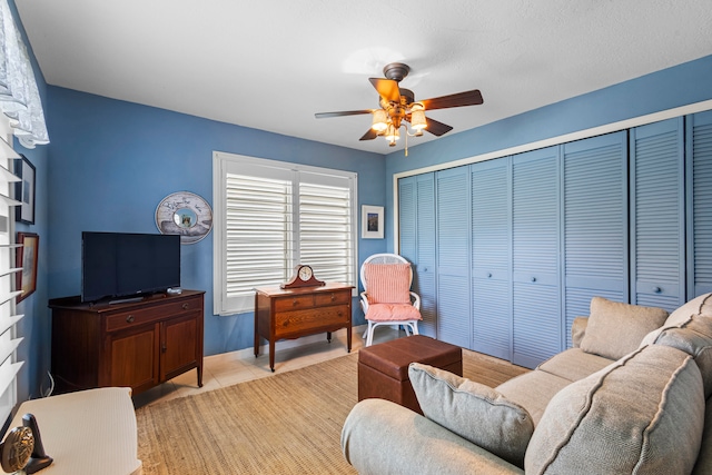 tiled living room featuring ceiling fan