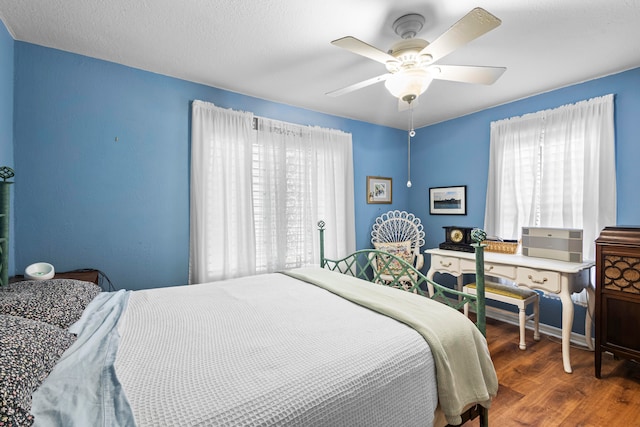 bedroom featuring hardwood / wood-style flooring and ceiling fan