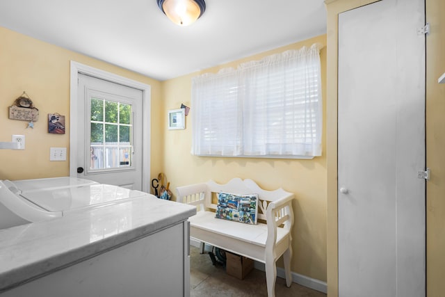 clothes washing area featuring washing machine and dryer and tile patterned flooring