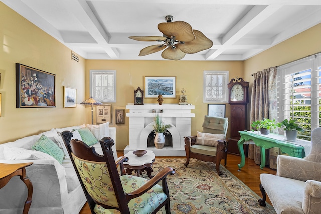 living room featuring hardwood / wood-style flooring, beam ceiling, and coffered ceiling