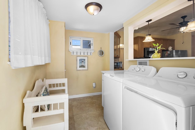 clothes washing area featuring light tile patterned flooring, separate washer and dryer, and ceiling fan