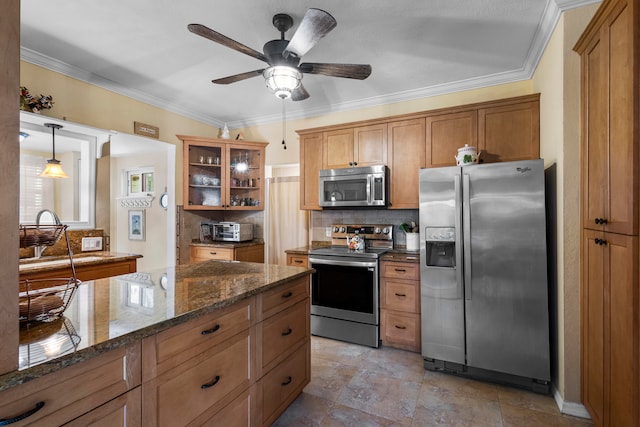 kitchen featuring appliances with stainless steel finishes, dark stone countertops, decorative backsplash, light tile patterned flooring, and ceiling fan