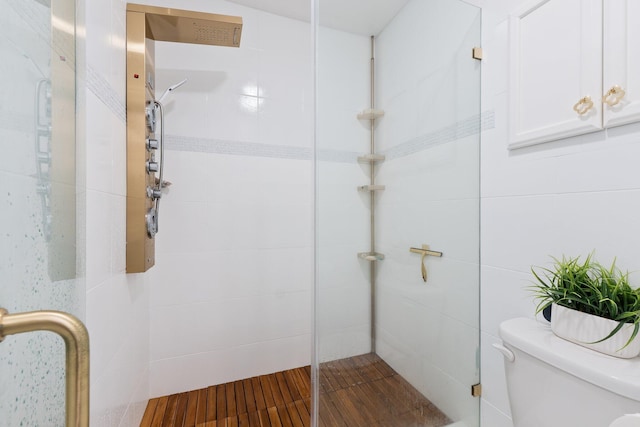 bathroom with toilet and an enclosed shower