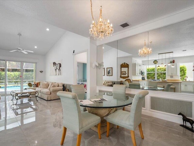 dining space featuring a textured ceiling, lofted ceiling, light tile patterned floors, and ceiling fan with notable chandelier