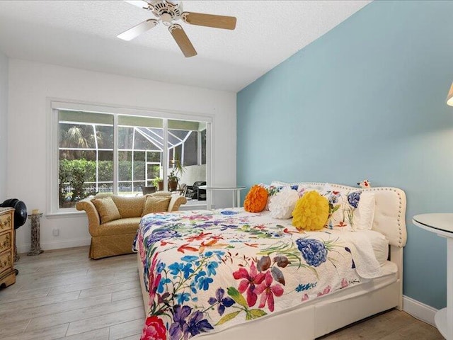 bedroom with vaulted ceiling, ceiling fan, and light wood-type flooring