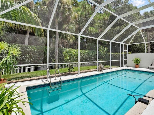 view of pool with glass enclosure