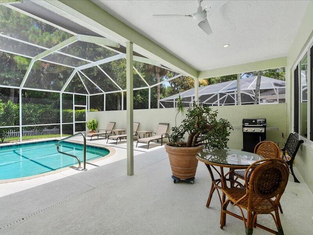 view of pool featuring grilling area, a patio, ceiling fan, and a lanai