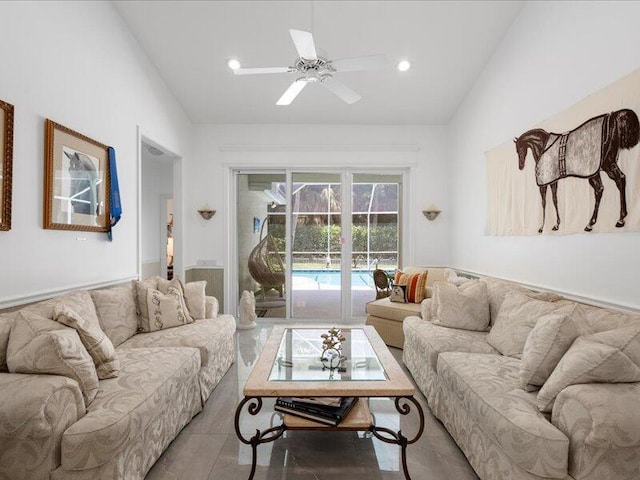 living room featuring ceiling fan, tile patterned floors, and vaulted ceiling