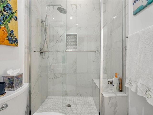 bathroom featuring a shower with shower door