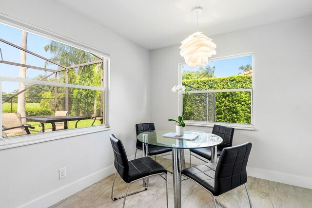 tiled dining space featuring a wealth of natural light