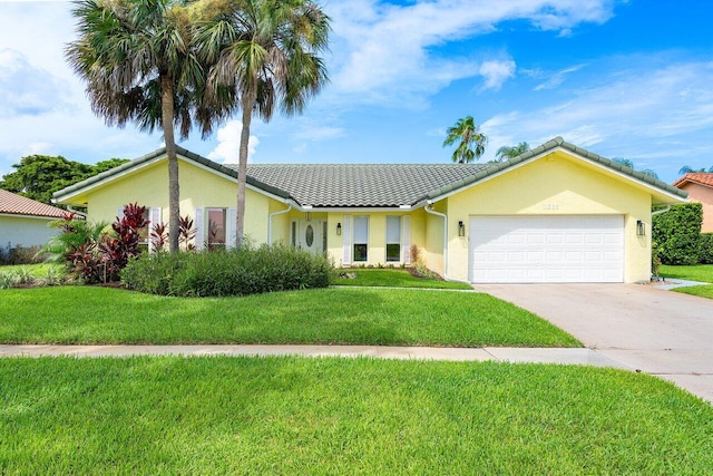 ranch-style home with a garage and a front lawn