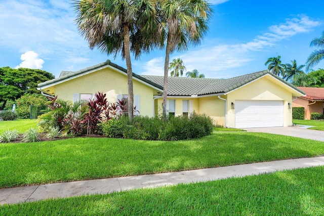 view of front facade with a garage and a front lawn