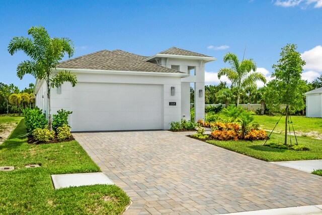 view of front of home featuring a garage and a front lawn