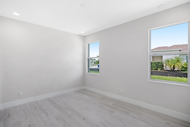 empty room featuring plenty of natural light and light hardwood / wood-style floors