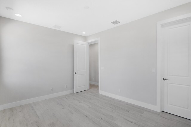 empty room with light hardwood / wood-style flooring