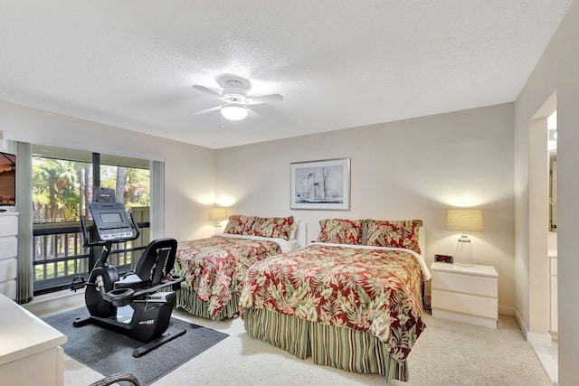 bedroom featuring light carpet, a textured ceiling, and ceiling fan