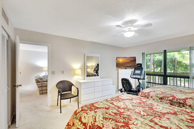 bedroom featuring a closet, ceiling fan, and a textured ceiling