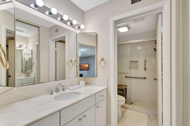 bathroom with vanity, toilet, an enclosed shower, and tile patterned flooring