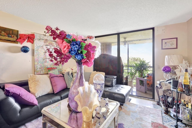 living room featuring expansive windows and a textured ceiling