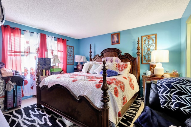 tiled bedroom featuring a textured ceiling