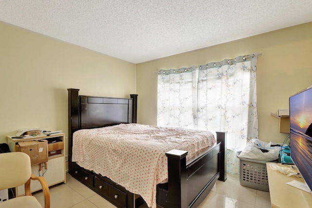 bedroom featuring a textured ceiling and light tile patterned floors