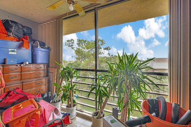 sunroom featuring ceiling fan