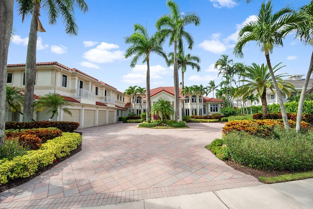 view of front of home with a garage and a balcony