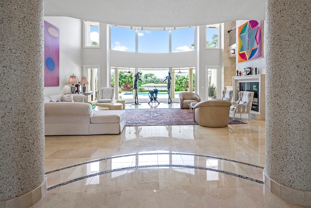 living room featuring light tile patterned flooring, a fireplace, and plenty of natural light