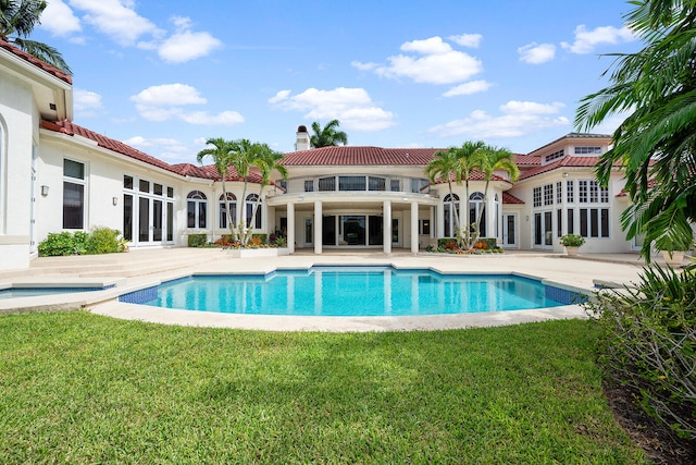 view of swimming pool featuring a patio and a lawn