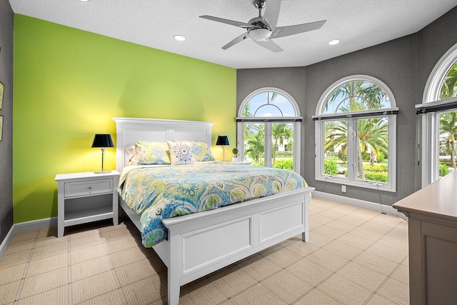 tiled bedroom with a textured ceiling and ceiling fan