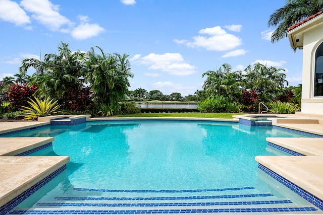 view of pool featuring an in ground hot tub