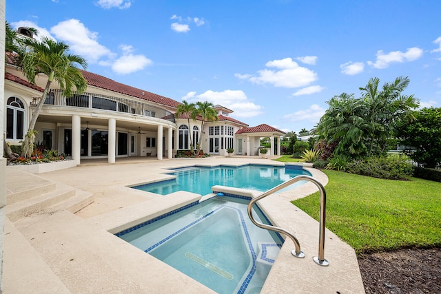 view of swimming pool with a patio, an in ground hot tub, ceiling fan, and a lawn