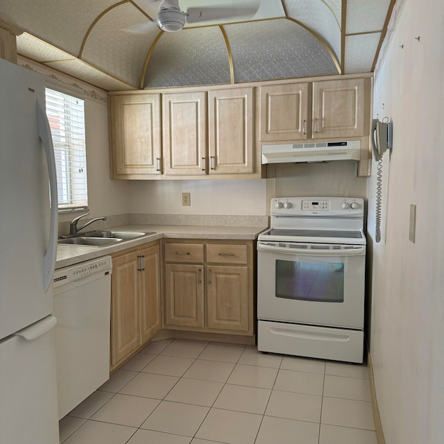 kitchen featuring white appliances, light brown cabinetry, sink, and light tile patterned floors