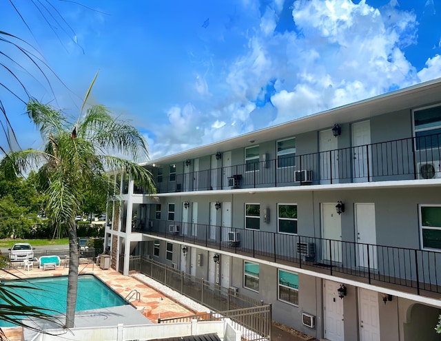 view of building exterior with a community pool