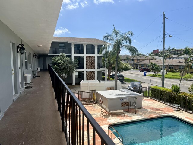 view of pool featuring a patio area and cooling unit