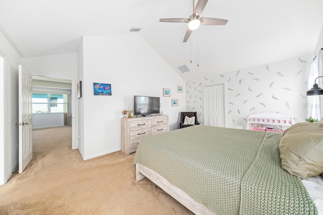 carpeted bedroom featuring ceiling fan, high vaulted ceiling, and a closet