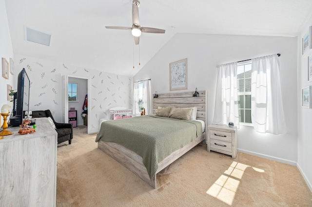 bedroom with light carpet, multiple windows, lofted ceiling, and ceiling fan