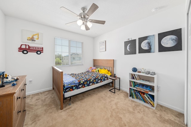 bedroom featuring light carpet and ceiling fan