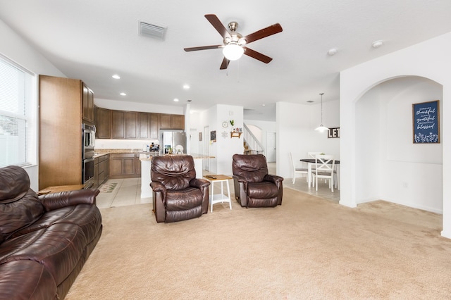 living room with ceiling fan and light carpet