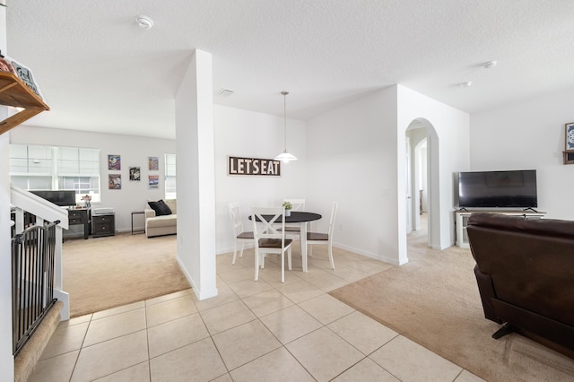 interior space with light colored carpet and a textured ceiling