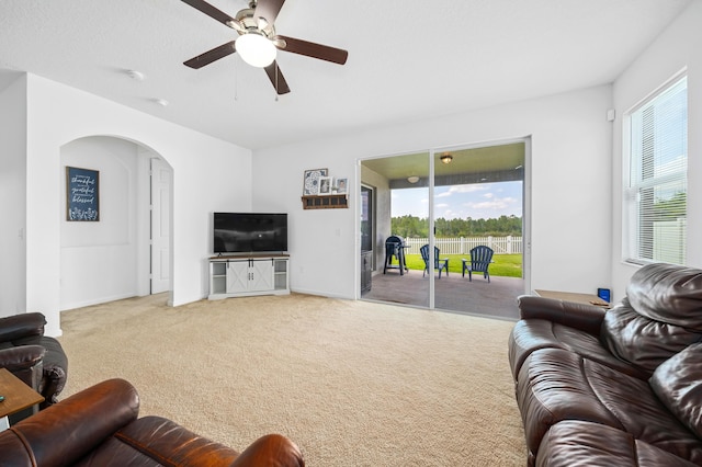 carpeted living room featuring ceiling fan