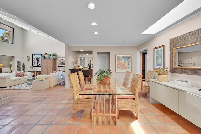 dining space featuring a skylight and light tile patterned floors