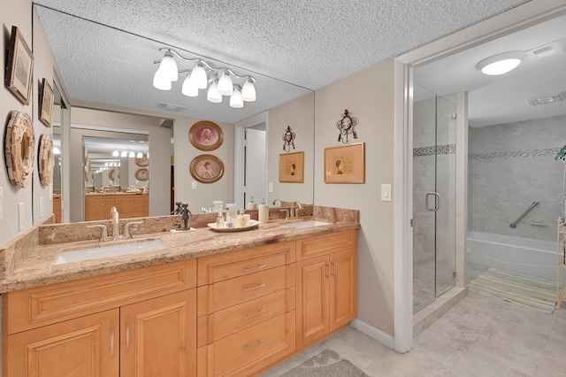 bathroom featuring a shower with door, a textured ceiling, tile patterned flooring, and double vanity