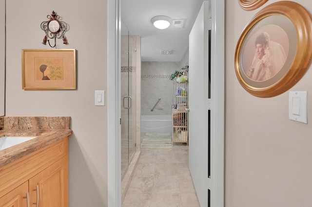 bathroom featuring tile patterned flooring, separate shower and tub, and vanity