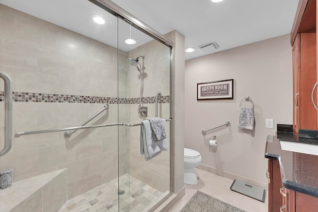 bathroom with vanity, tile patterned floors, walk in shower, and toilet