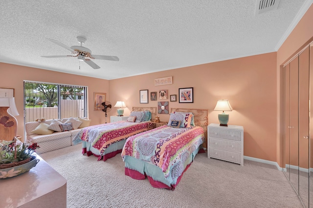 carpeted bedroom featuring a closet, a textured ceiling, and ceiling fan