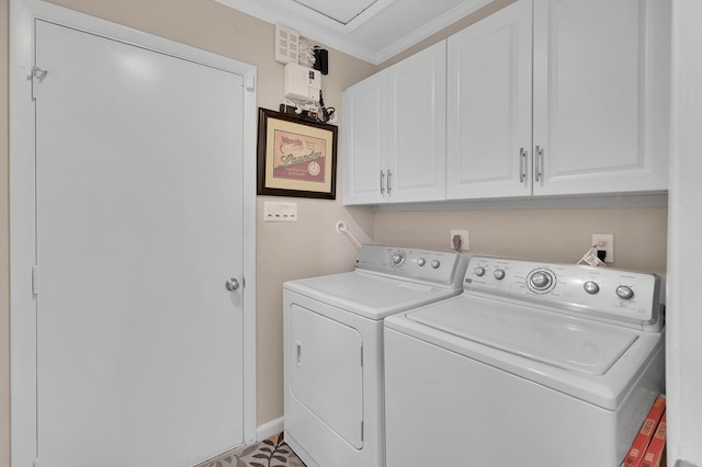 washroom featuring tile patterned floors, washer and dryer, cabinets, and ornamental molding