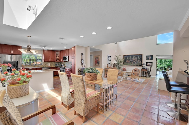 dining area with ceiling fan and light tile patterned floors