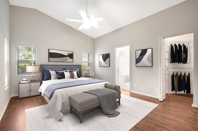8278 Duomo Cir, Boynton Beach, FL 33472 - bedroom featuring multiple windows, a spacious closet, wood finished floors, high vaulted ceiling, and baseboards