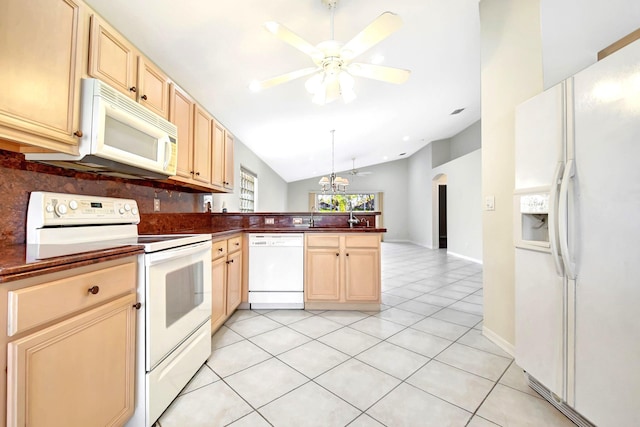 kitchen with lofted ceiling, tasteful backsplash, light tile patterned floors, white appliances, and ceiling fan with notable chandelier